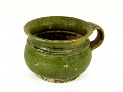 Dark green, round pot with loop handle on the right. Some damage to the green glaze. To magnify click now