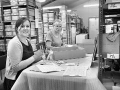 Catriona working on the archaeology inventory with volunteer Chris in the main store