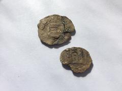 Two Medieval cloth seals from Guildford which were attached to cloth after being checked for quality