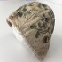 Baby's cap with embroidered leaves flowers