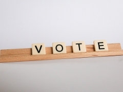 Voting Scrabble tiles that spell vote