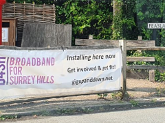 Photo of broadband for Surrey Hills banner on a wooden fence