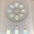 a circular stained glass window inside the chapel