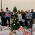 some members from Volker Fitzpatrick, the Food Parcels Project team and councillor Carla Morson standing next to a Christmas tree and a pile of donated christmas presents