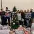 some members from Volker Fitzpatrick, the Food Parcels Project team and councillor Carla Morson standing next to a Christmas tree and a pile of donated christmas presents 