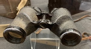 A pair of binoculars on a glass counter
